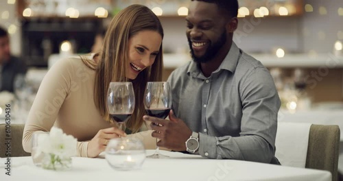 Talking, whisper or happy interracial couple in restaurant to celebrate marriage anniversary at dinner at night. Chat, romantic black man or woman fine dining on wine date bonding on valentines day