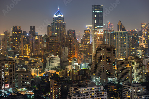 Night urban cityscape skyline of modern illuminated Bangkok city with glowing skyscrapers and buildings in dusk. High-angle view on colorful Metropolis lights in twilight © evgenydrablenkov