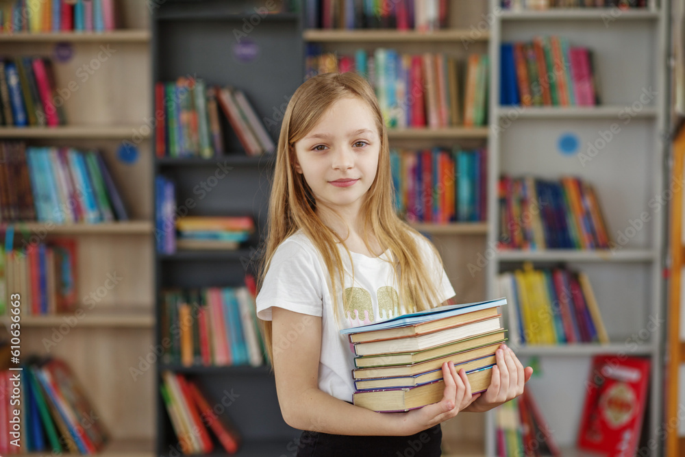 Child buys books in bookstore for learning or reading. Girl choosing book in school library. Child buys books in bookstore for learning or reading. Girl choosing book in school library.