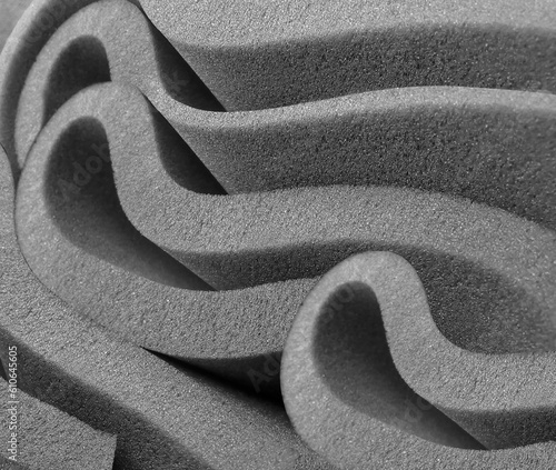 rolled gray foam sponge. foam sponge rubber texture sheet. irregular folds of material