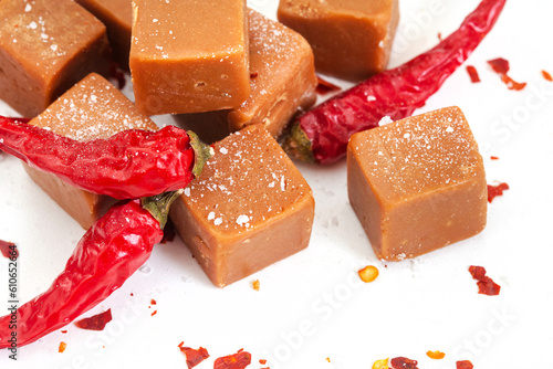 caramel fudge with chili flakes and coarse salt, sweet, spice, salty on white
 photo