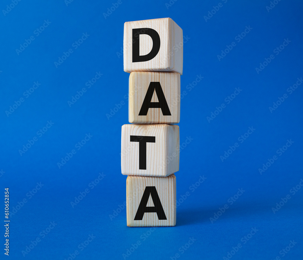 Data symbol. Concept word Data on wooden cubes. Beautiful blue background. Business and Data concept. Copy space. Data symbol. Concept word Data on wooden cubes. Beautiful blue background. Business and Data concept. Copy space.
