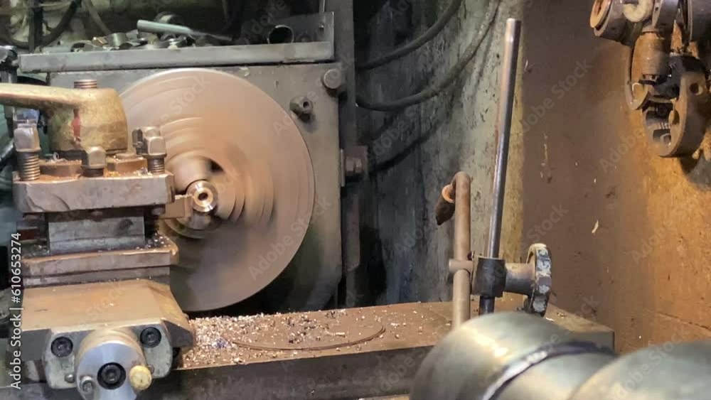 The machine is in operation. Grind a part made of brass metal. Work in the old workshop. Sculpt the desired thing from metal. The craftsman works on a milling machine. High quality 4k footage The machine is in operation. Grind a part made of brass metal. Work in the old workshop. Sculpt the desired thing from metal. The craftsman works on a milling machine. High quality 4k footage