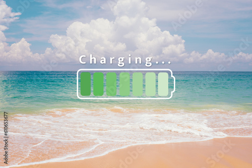 Fully charge battery 100% sign icon on natare summer beach on vacation day. Holiday long weekend relax time concept. photo