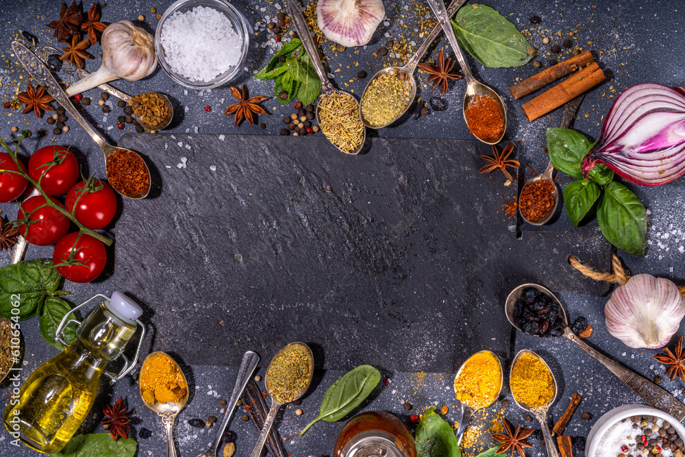 Spices for cooking on dark background . Different seasonings, spices and herbs paprika, pepper, turmeric, salt, basil, mint, cinnamon, garlic and other aromatic ingredients for preparation food
