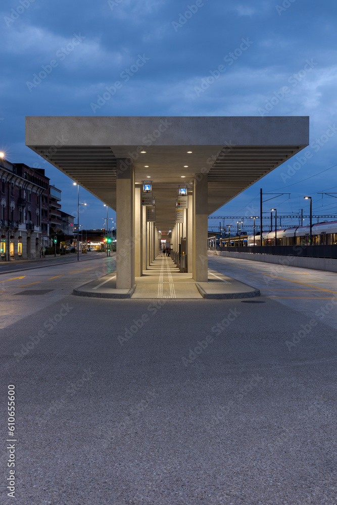 Modern bus stop shelter in Mendrisio. There is a long, lighted corridor with several stops. Modern bus stop shelter in Mendrisio. There is a long, lighted corridor with several stops.