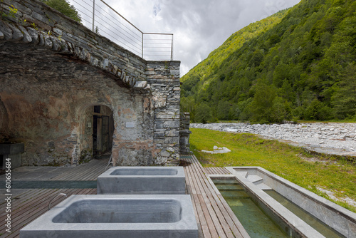 Thermal baths with a view of the river and Swiss nature. Behind it is a cave. photo