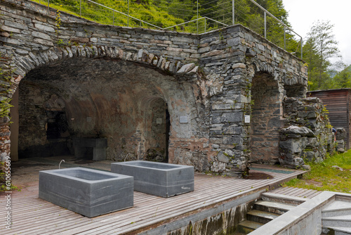 Thermal baths with a view of the river and Swiss nature. Behind it is a cave. photo