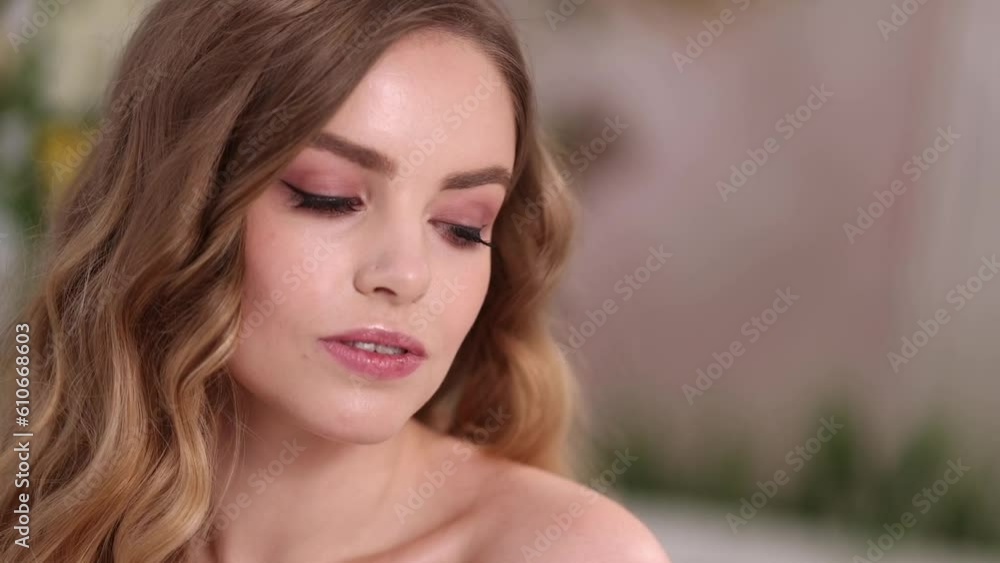 Caucasian woman with blond long hair and bare shoulders opens her beautiful eyes and looks into the camera. Attractive spa model Girl with perfect fresh clean skin. Caucasian woman with blond long hair and bare shoulders opens her beautiful eyes and looks into the camera. Attractive spa model Girl with perfect fresh clean skin.