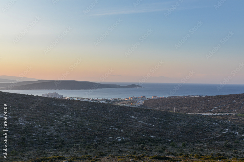 scenic view of Alacati coast and Yumru Koyu Bay at sunrise from local hills (Cesme, Izmir province, Turkiye)