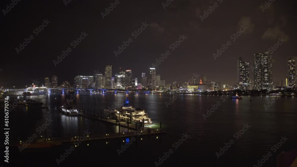 Lockdown Shot Of Yachts Moored At Harbor Near Modern City Against Sky At Night - Miami, Florida Lockdown Shot Of Yachts Moored At Harbor Near Modern City Against Sky At Night - Miami, Florida