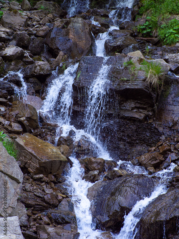 Cascade Trufanets Falls. Landscape of waterfall in the Ukrainian Carpathian Mountains. The water flows beautifully over the rocks. Mountain river. Beautiful big waterfall in the mountains. Cascade Trufanets Falls. Landscape of waterfall in the Ukrainian Carpathian Mountains. The water flows beautifully over the rocks. Mountain river. Beautiful big waterfall in the mountains.