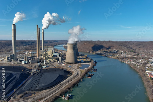 Power Plant with Blue Sky in Bend of Green River and Pile of Black Coal