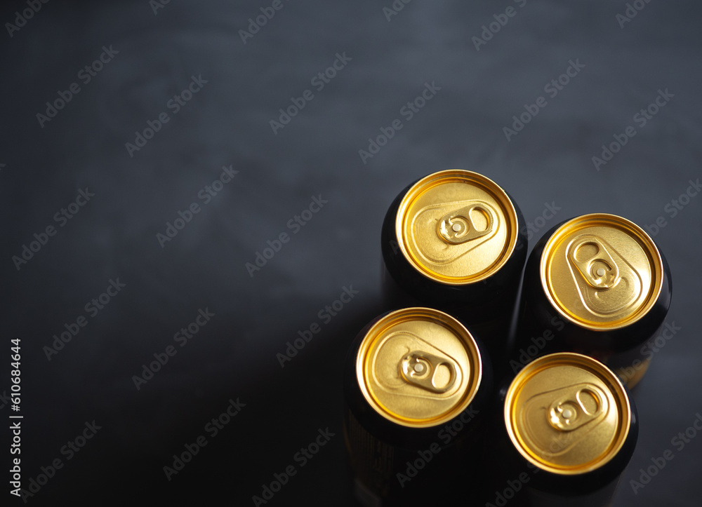 Four beer cans on black table top view with copy space Four beer cans on black table top view with copy space