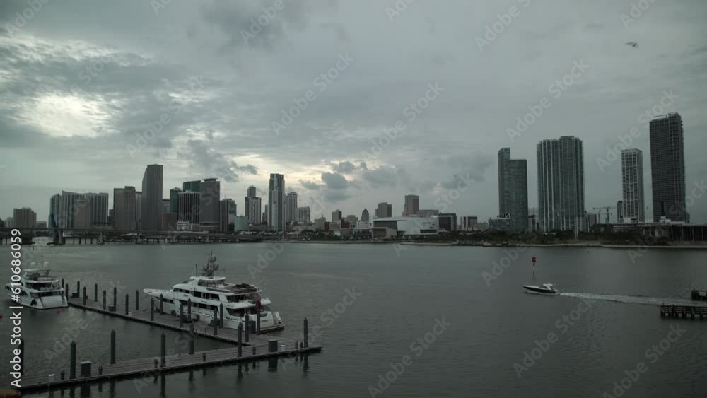 Lockdown Shot Of Yachts At Harbor Near Modern Buildings In City Against Cloudy Sky At Dusk - Miami, Florida Lockdown Shot Of Yachts At Harbor Near Modern Buildings In City Against Cloudy Sky At Dusk - Miami, Florida