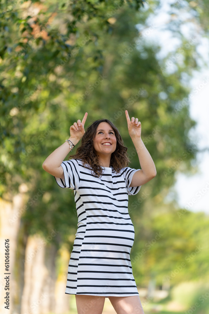 Photo with copy space to insert something with a pregnant woman pointing up Photo with copy space to insert something with a pregnant woman pointing up