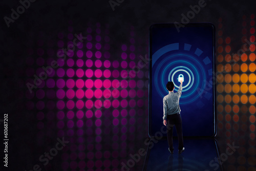 Businessman standing on a cellphone touching a lock symbol on screen photo