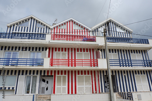 Row of lined colourful beach houses on in Aveiro, Portugal. Portuguese architecture of red, white and blue colours