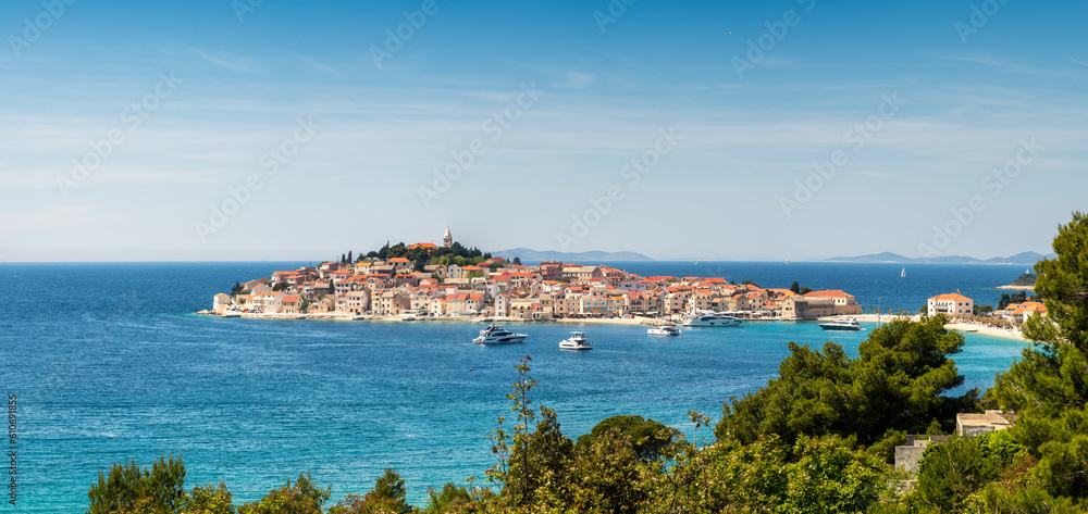 Aerial panoramic view with scenic town of Primosten in Croatia, famous and picturesque tourist resort at Adriatic sea coast.