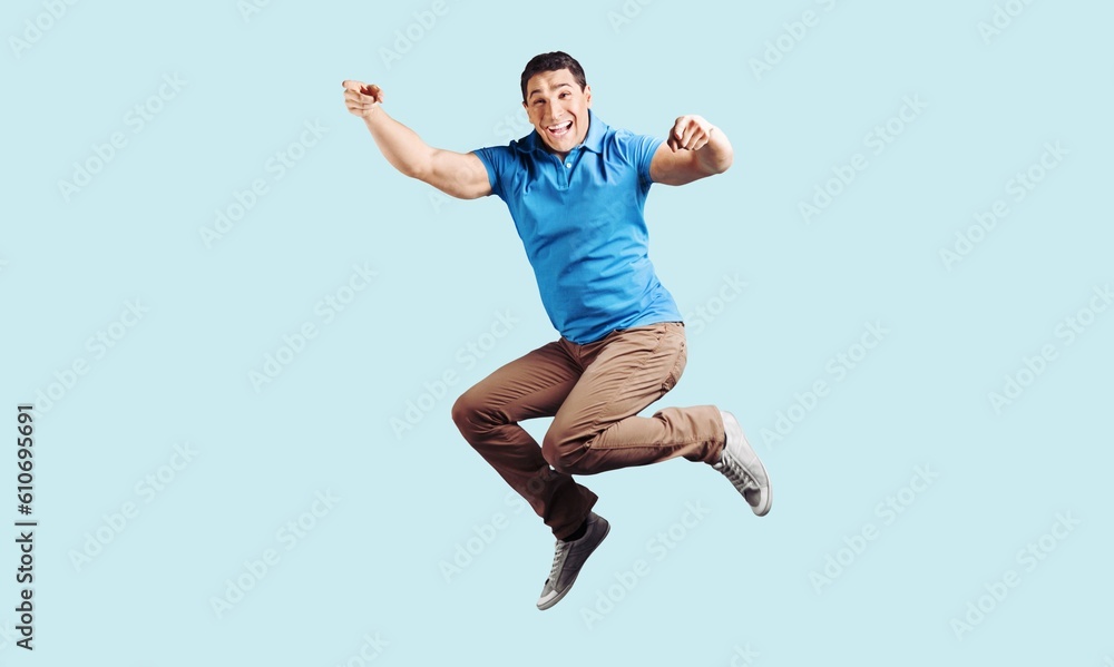Fototapeta premium Young fun person jump on background