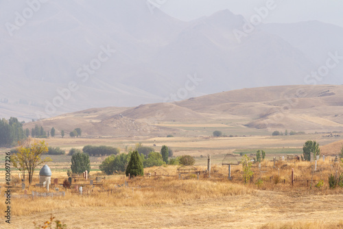 Fototapeta Naklejka Na Ścianę i Meble -  Ancient Kyrgyz cemetery with stone buildings in Shabdan village, Chong-Kemin National Park near Tian Shan mountains, Kyrgyzstan