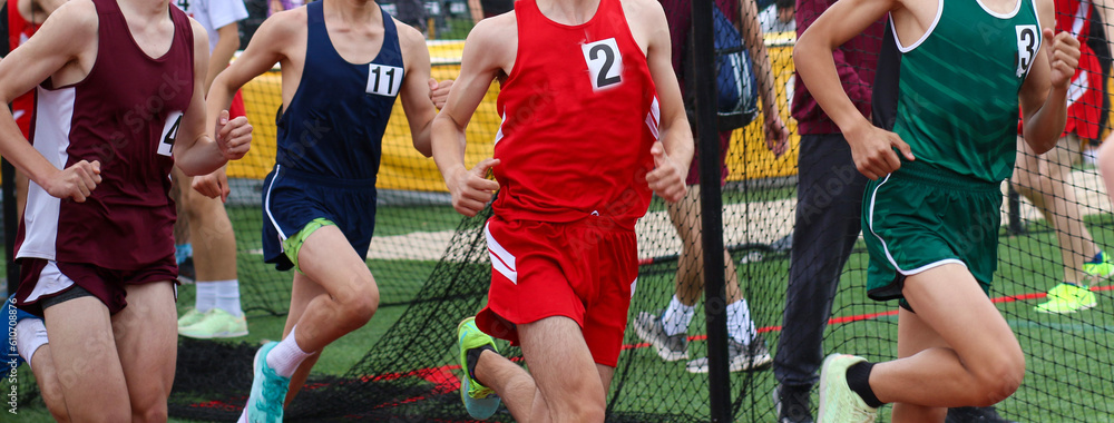 Group of runners racing the mile on a track Group of runners racing the mile on a track
