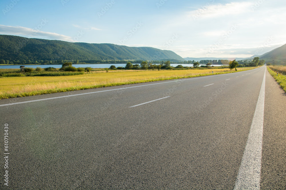 Fototapeta premium straight empty road at sunset