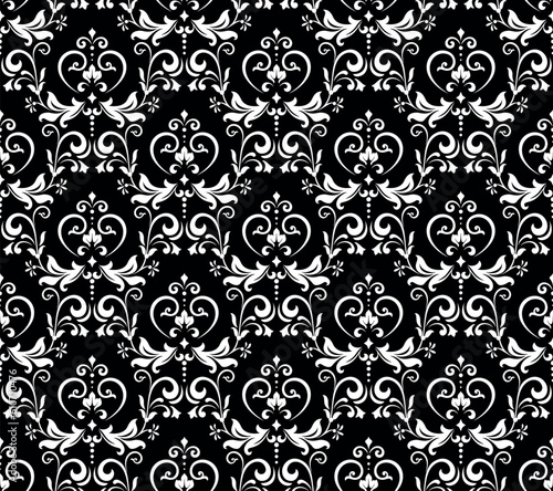 Wallpaper in the style of Baroque. Seamless vector background. White and black floral ornament. Graphic pattern for fabric, wallpaper, packaging. Ornate Damask flower ornament