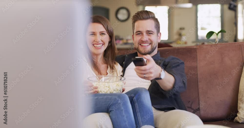 Happy couple, sofa and popcorn for romantic movies, comedy or watching tv together in home living room. Man, woman and comic television show on lounge couch with eating snack, relax or bond with love Happy couple, sofa and popcorn for romantic movies, comedy or watching tv together in home living room. Man, woman and comic television show on lounge couch with eating snack, relax or bond with love