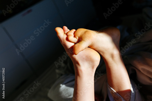 child's bare feet in the early morning bright light © Victoria