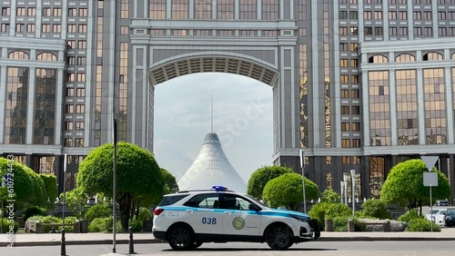 Astana, Kazakhstan, May 2023. View of Khan Shatyr. A police patrol car passes by on the road.