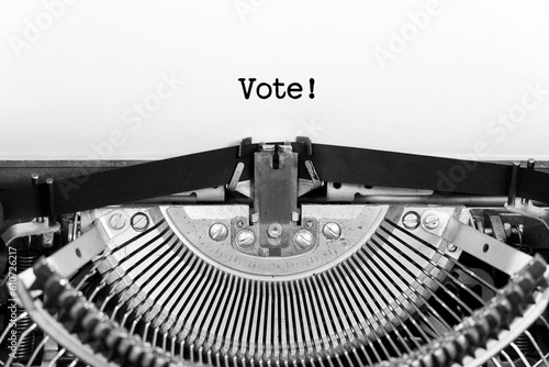 Vote word close up being typing and centered on a sheet of paper on old vintage typewriter mechanical