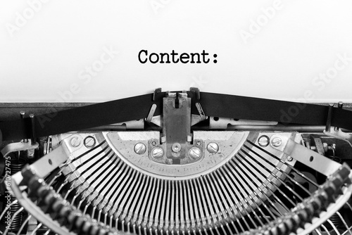 Content word close up being typing and centered on a sheet of paper on old vintage typewriter mechanical