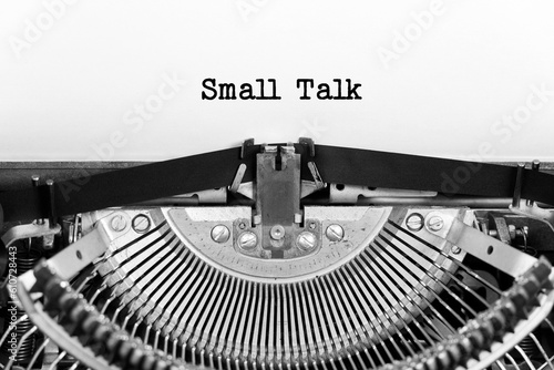 Small Talk phrase close up being typing and centered on a sheet of paper on old vintage typewriter mechanical