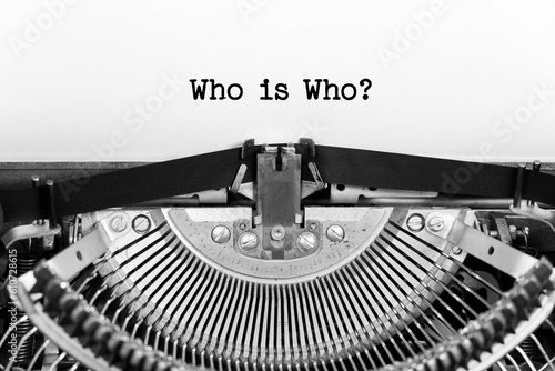 Who Is Who phrase close up being typing and centered on a sheet of paper on old vintage typewriter mechanical