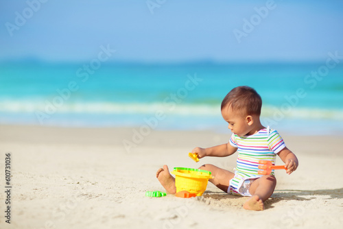 Baby playing on beach. Children play at sea. © famveldman