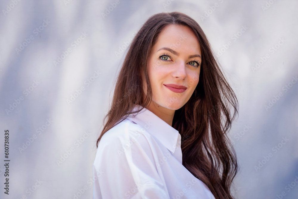 Headsho of young woman with beautiful blue eyes and brunette hair standing at sunlight Headsho of young woman with beautiful blue eyes and brunette hair standing at sunlight