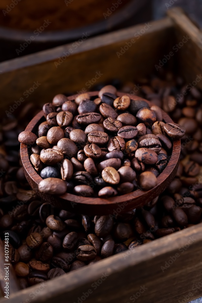 Roasted coffee beans in a rustic wooden bowl