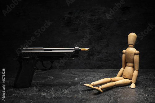 Wooden mannequin and gun lo...