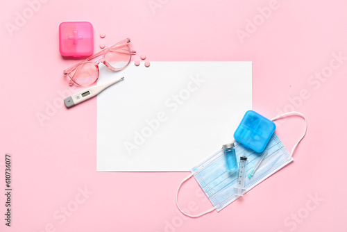 Composition with blank card, medicines, thermometer and medical mask on pink background. Melanoma concept