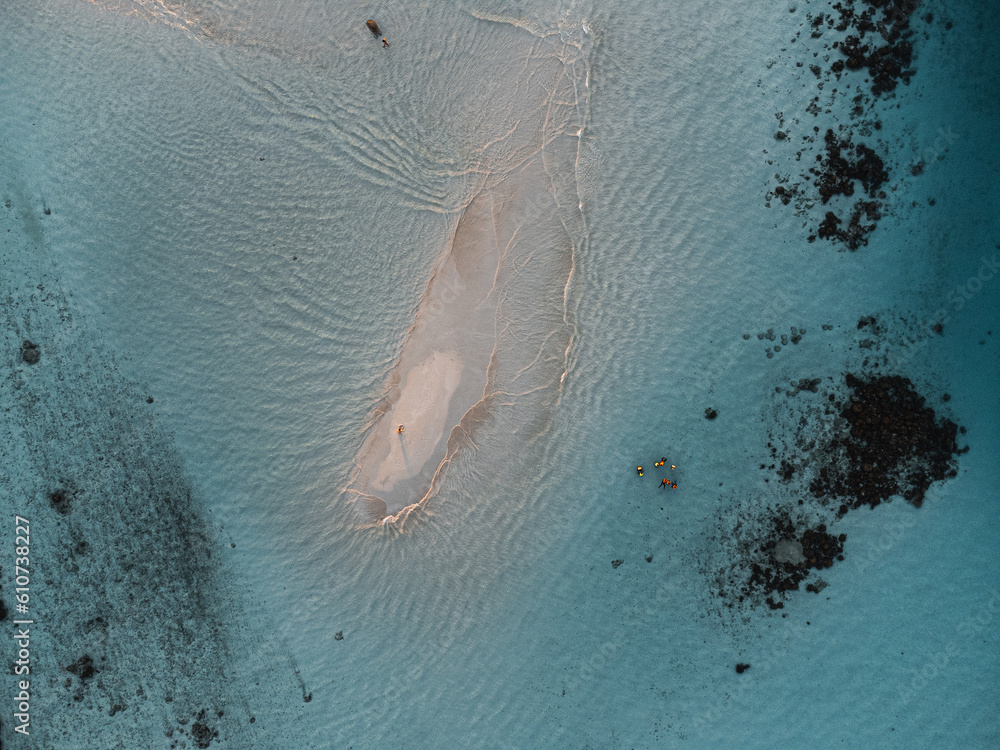 Sandbank in the middle of crystal clear water, seen from the air (above).