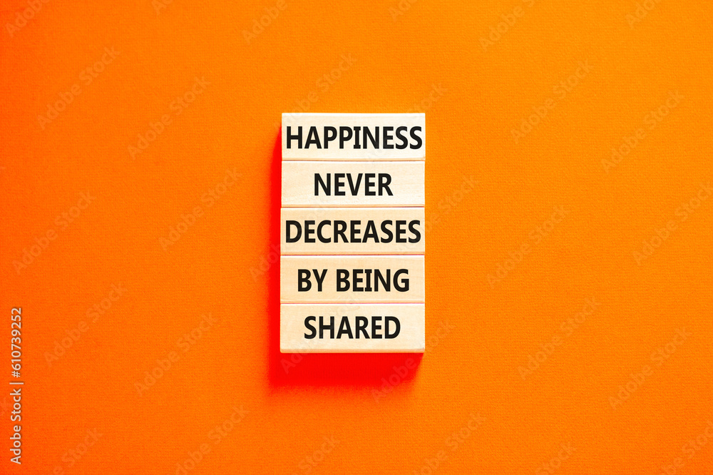 Naklejka premium Happiness symbol. Concept words Happiness never decreases by being shared on wooden block. Beautiful orange table orange background. Motivational Happiness concept. Copy space.
