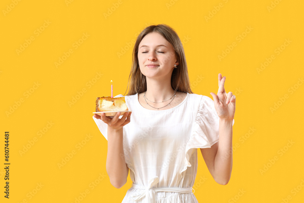 Pretty young woman with birthday cake making wish on yellow background Pretty young woman with birthday cake making wish on yellow background