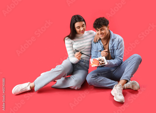 Young couple eating sushi o...