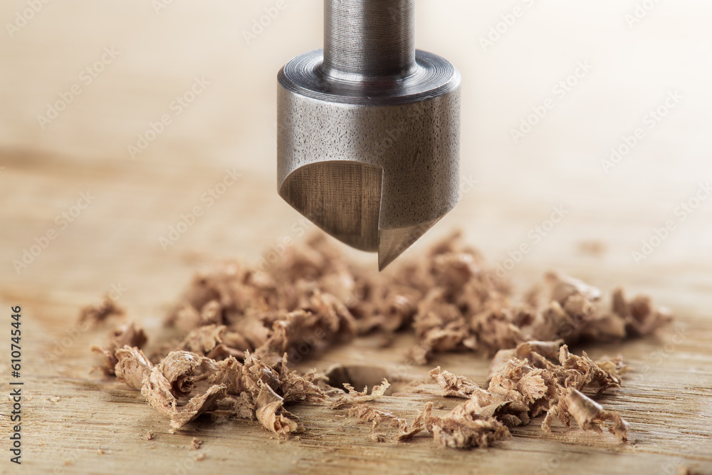 Countersink drill bit with steel triangle ruler make sink in hole for screw in wooden oak plank Countersink drill bit with steel triangle ruler make sink in hole for screw in wooden oak plank