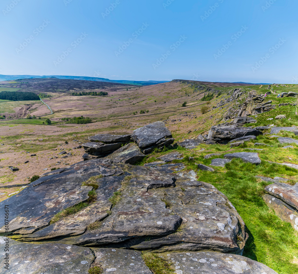 A view over millstone slabs on top of the Stanage Edge escarpment in the Peak District, UK in summertime