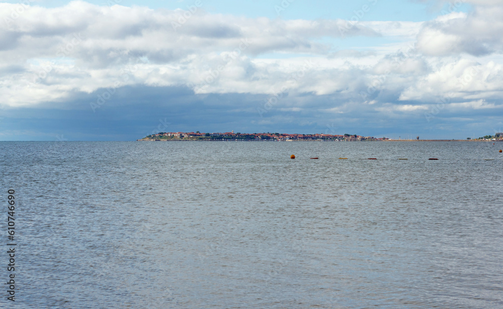Landscape, amazing view of island of Nessebar in distance, sea and clouds. Beautiful summer holiday at sea Landscape, amazing view of island of Nessebar in distance, sea and clouds. Beautiful summer holiday at sea