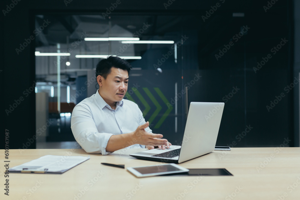 Online consultation with the client. A young male office worker, a sales and service manager communicates via video call from a laptop. Online consultation with the client. A young male office worker, a sales and service manager communicates via video call from a laptop.