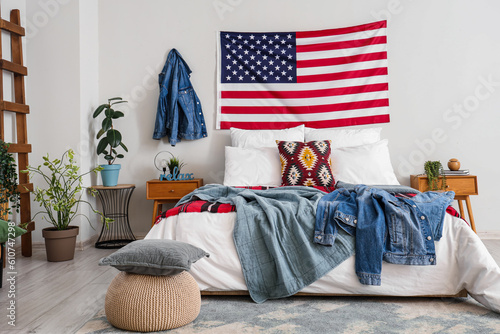 Interior of bedroom with USA flag and denim jackets © Pixel-Shot