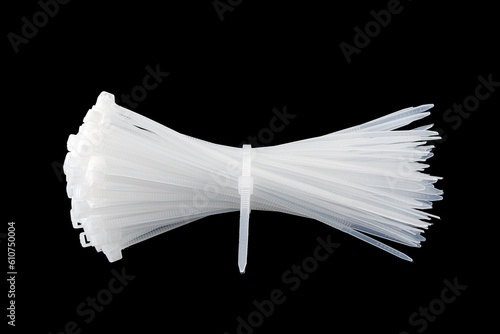 White plastic cable ties isolated on black background. plastic wire ties close up. photo